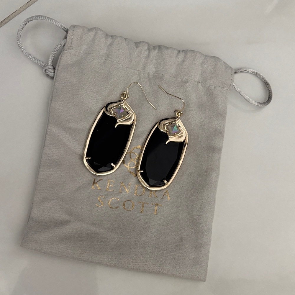 Kendra Scott Gabby gold earrings featuring black and iridescent stones.